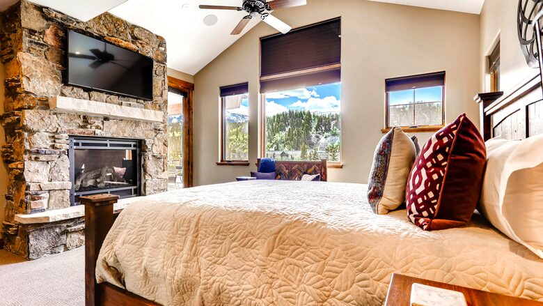 Home Exchange in Breckenridge, CO master suite with a fireplace