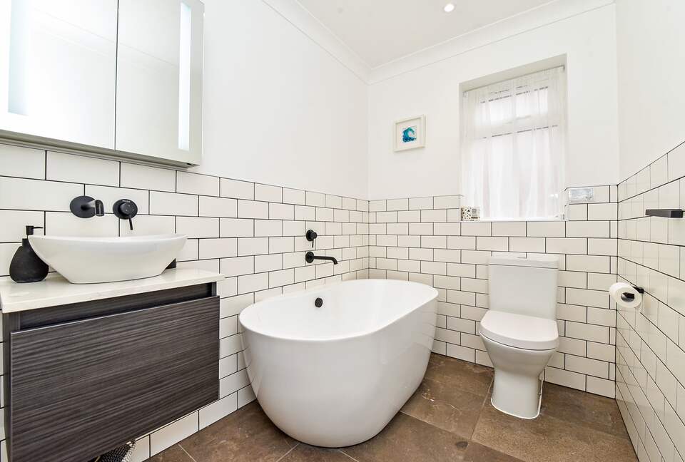 Bathroom. Free standing tub, oval counter top sink & WC.