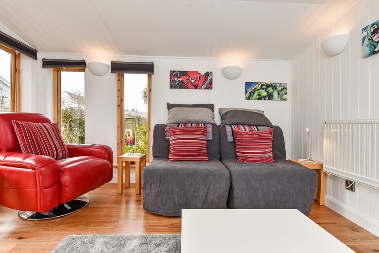Garden room interior. Leather chair. Chair beds. Heating.