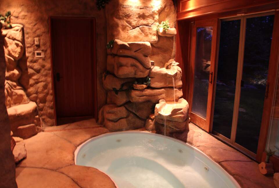 Hot tub with waterfall (sliding doors open fully to outside)
