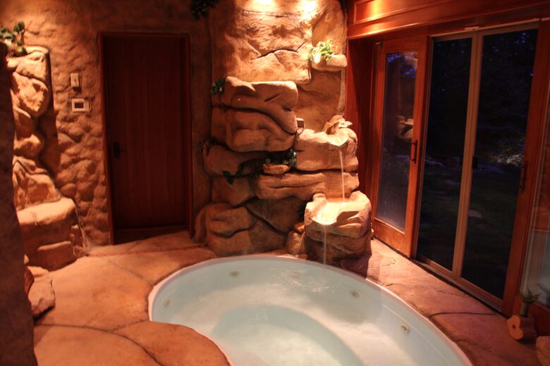 Hot tub with waterfall (sliding doors open fully to outside)