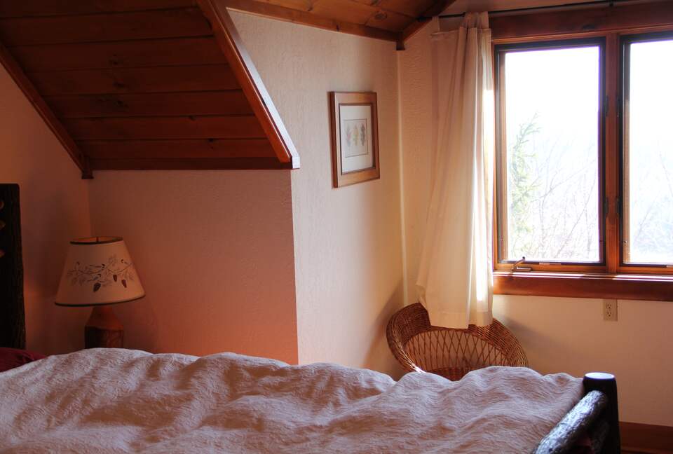 Upstairs bedroom with lake view; private bath