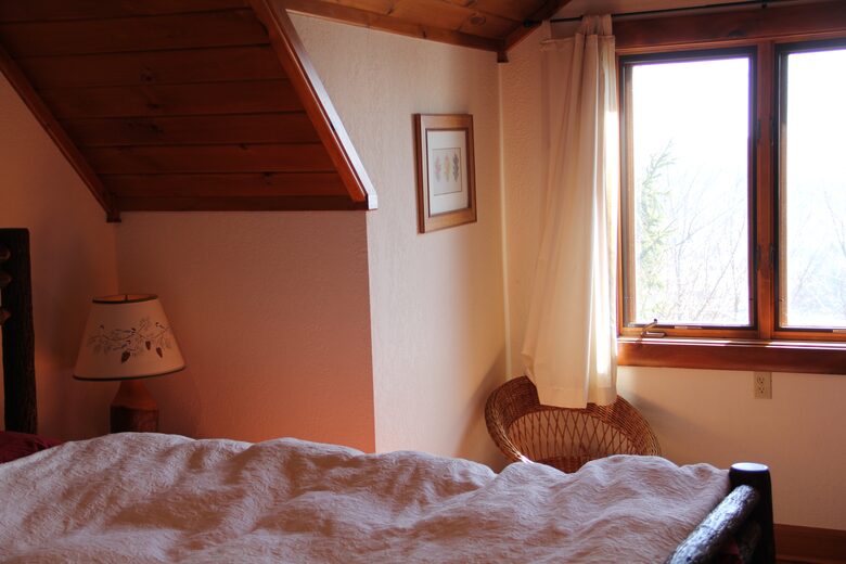 Upstairs bedroom with lake view; private bath