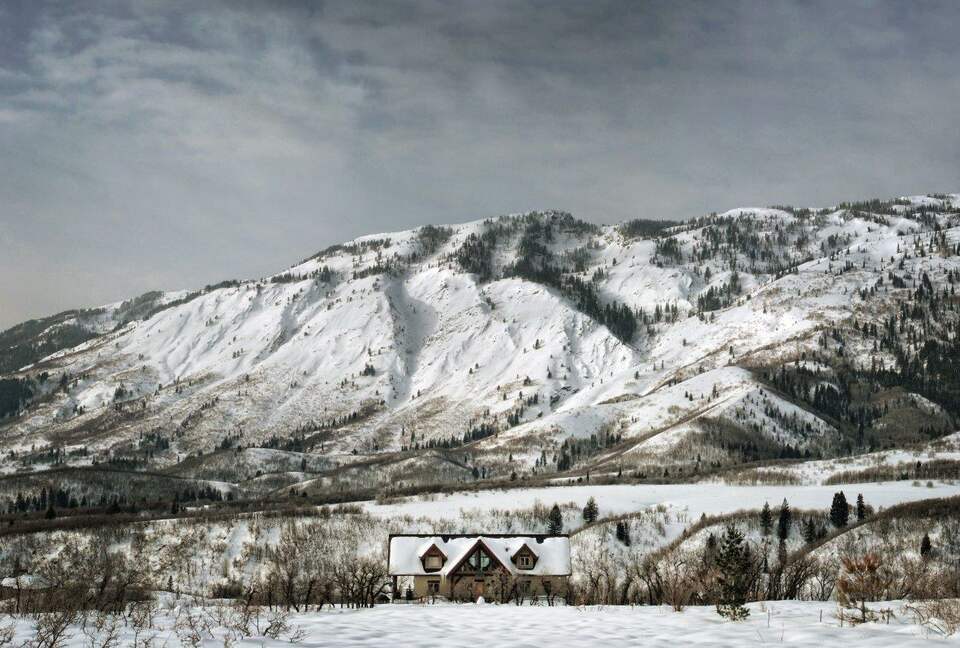 Home Exchange in Eden, UT Liberty Lodge in front of the snowy mountain