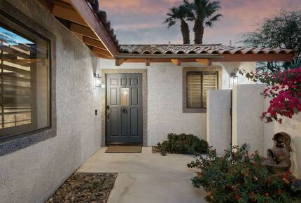 Home Exchange in La Quinta, CA front doors of the Spanish style home