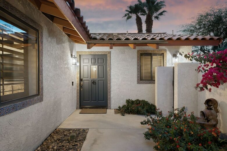 Home Exchange in La Quinta, CA front doors of the Spanish style home