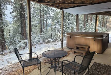 Home Exchange in Lead, SD covered patio with hot tub and dining