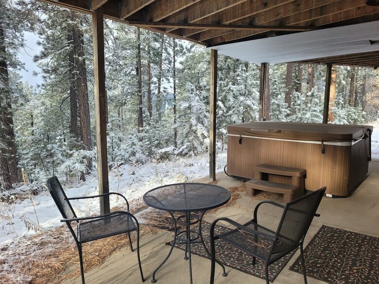 Home Exchange in Lead, SD covered patio with hot tub and dining