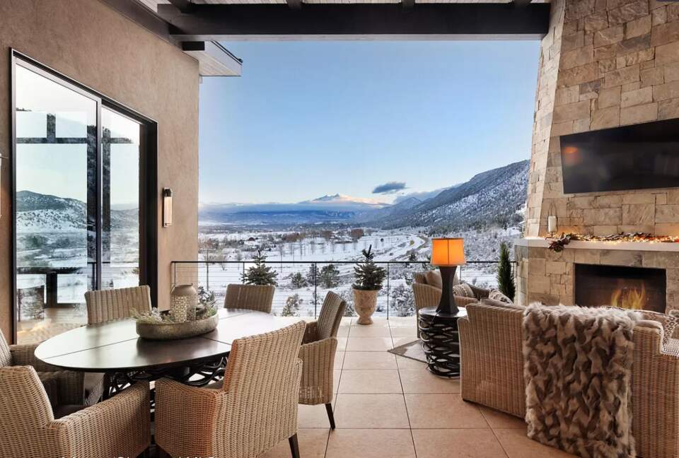 Outdoor covered patio with dining and fireplace