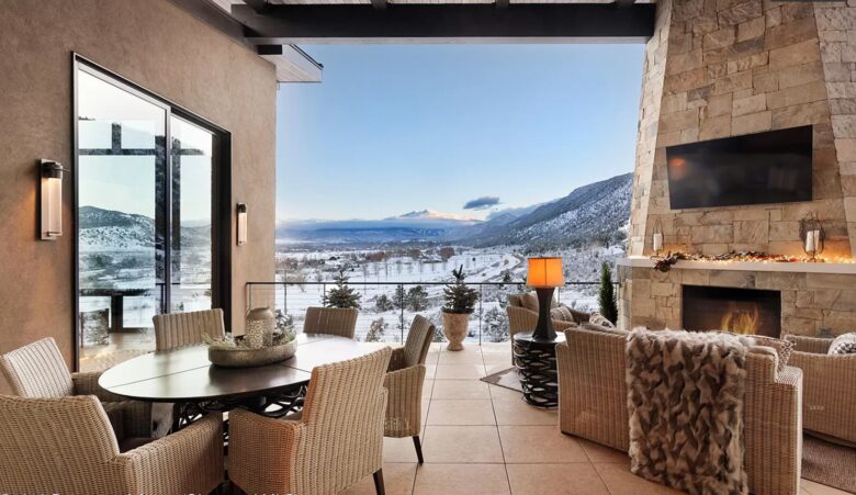 Outdoor covered patio with dining and fireplace