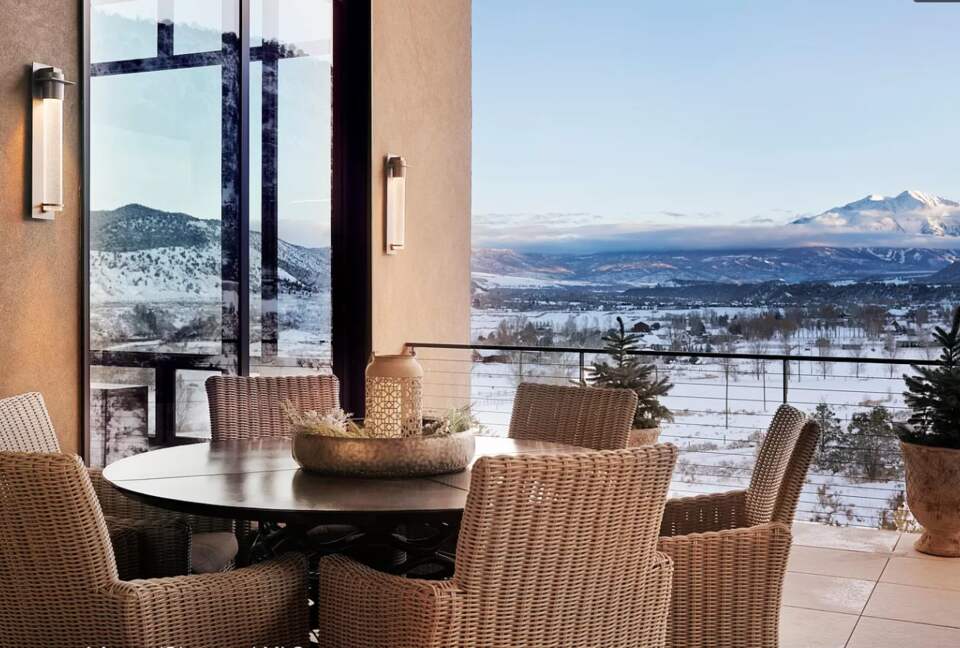 Outdoor covered patio with dining and fireplace