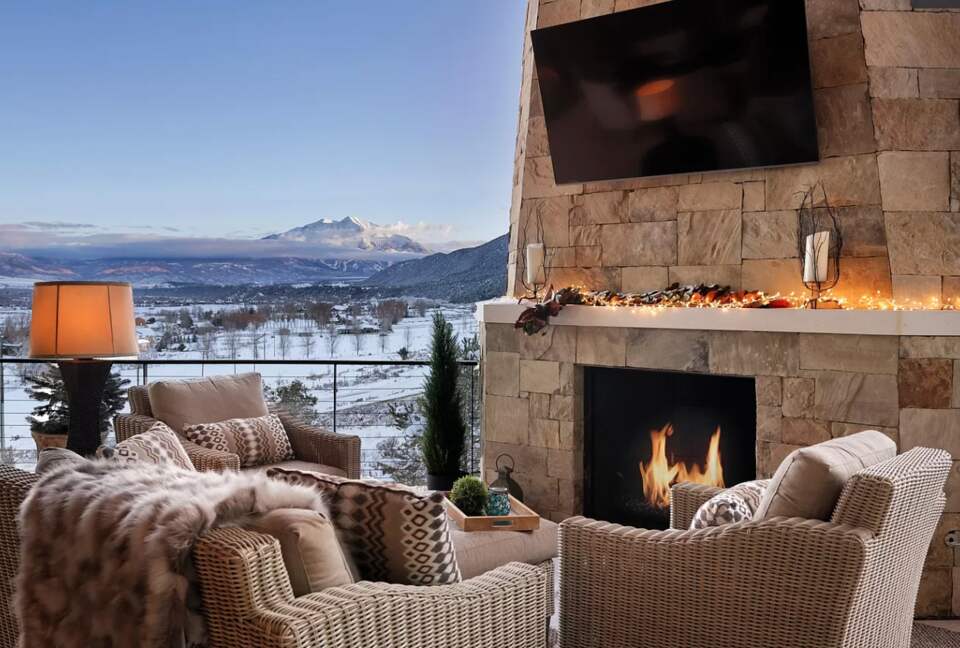 Outdoor covered patio with dining and fireplace