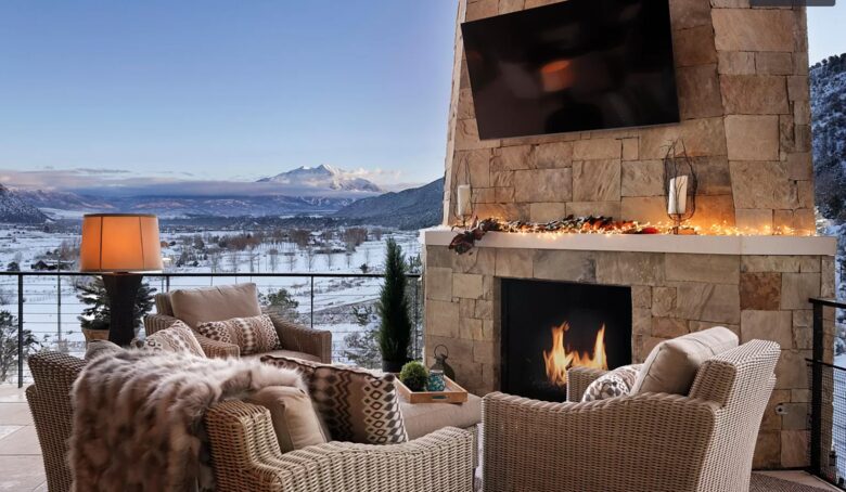 Outdoor covered patio with dining and fireplace