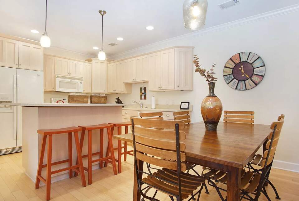 Dining table seats six. Additional seating at bar