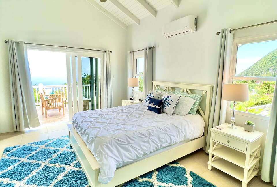 Master Suite with ocean views and private bath, and balcony.