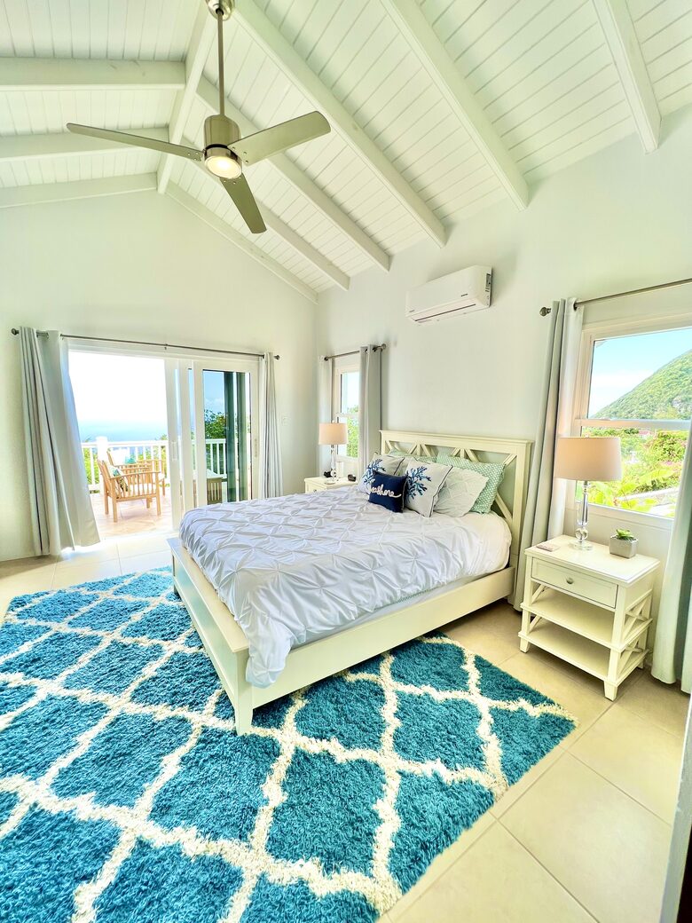 Master Suite with ocean views and private bath, and balcony.