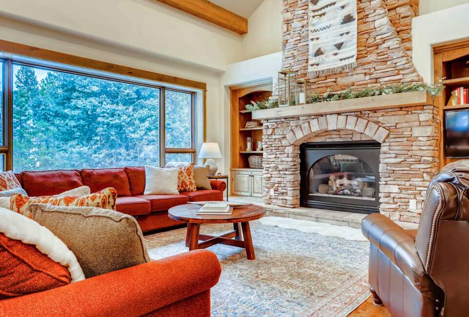Living room with fireplace and views