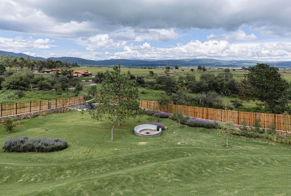 Garden with small lake and fire pit