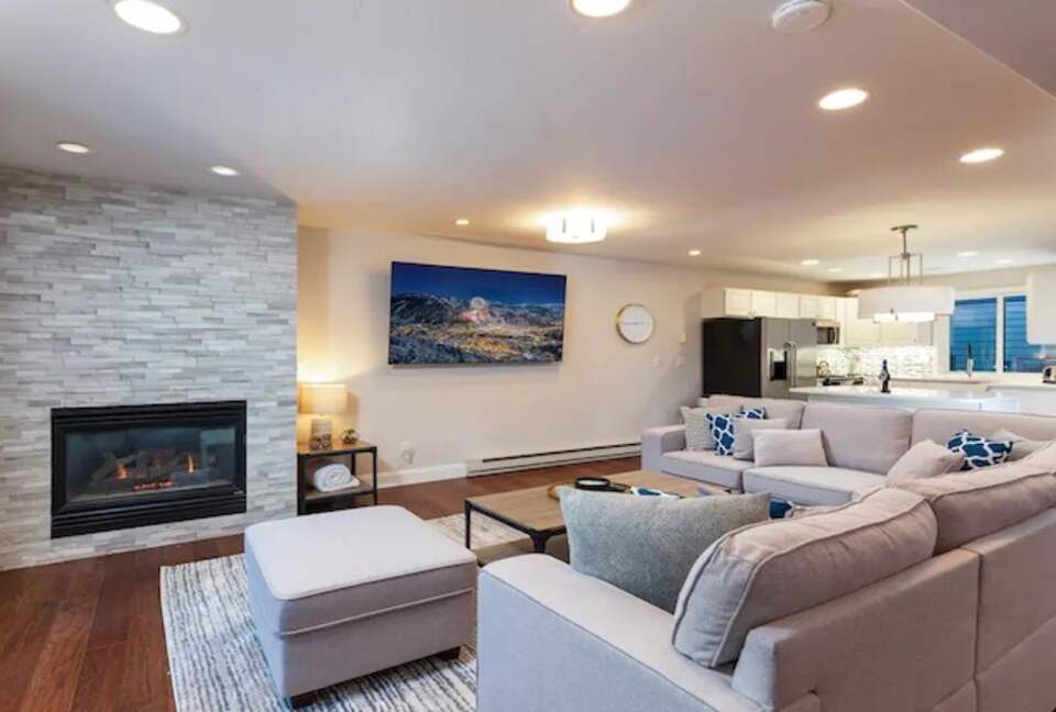 Open living room with fireplace and balcony