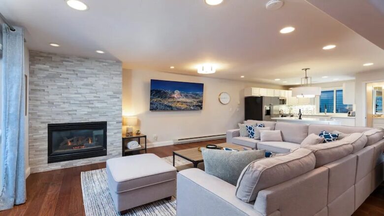 Open living room with fireplace and balcony