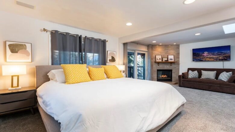 Master bedroom with sofa bed and fireplace