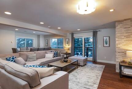 Open living room with fireplace and balcony