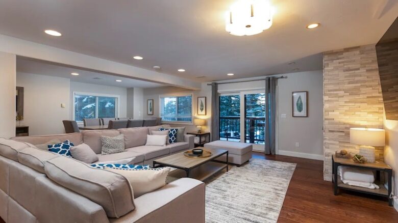 Open living room with fireplace and balcony