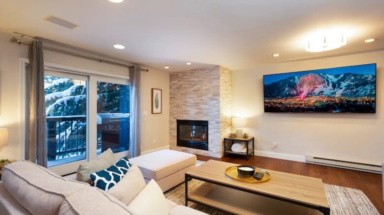 Open living room with fireplace and balcony
