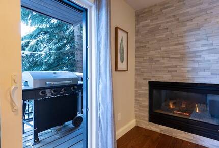 Open living room with fireplace and balcony