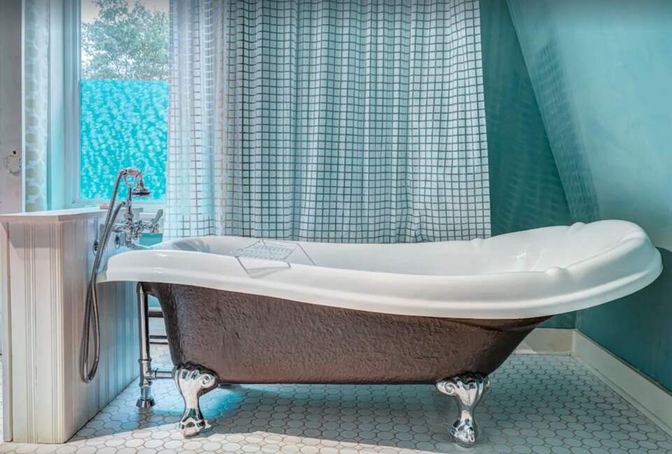 Bathroom with claw foot tub and shower