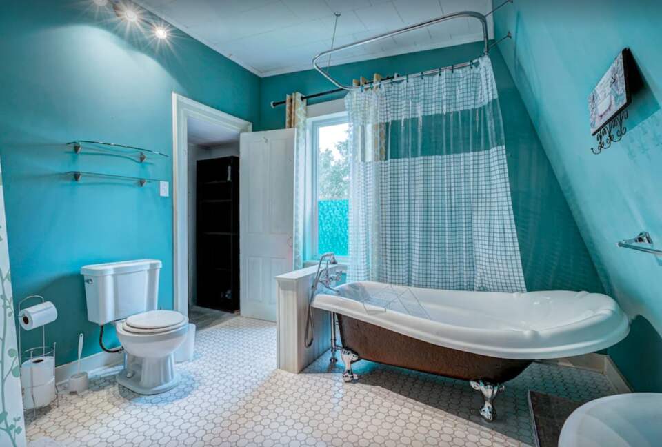 Bathroom with claw foot tub and shower
