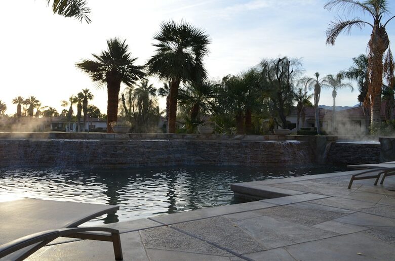 Home Exchange in La Quinta, CA lounge by the luxurious pool