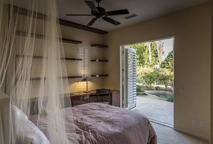 Home Exchange in La Quinta, CA guest bedroom with patio