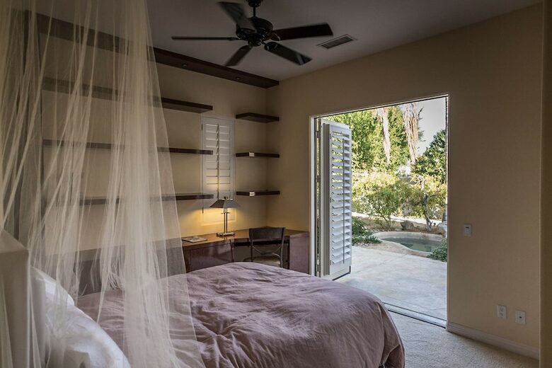 Home Exchange in La Quinta, CA guest bedroom with patio