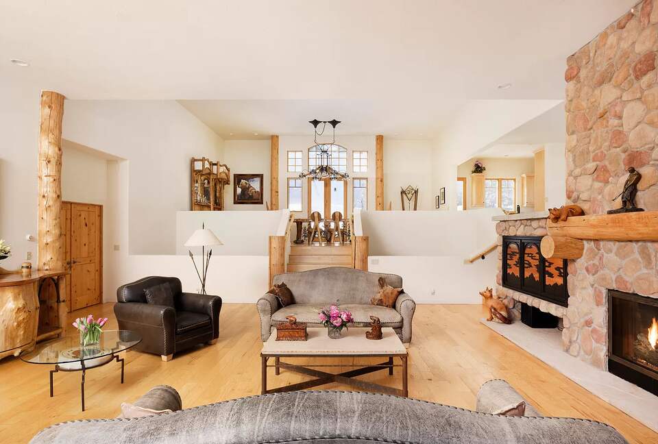 Home Exchange in Snowmass Village family room with stone fireplace
