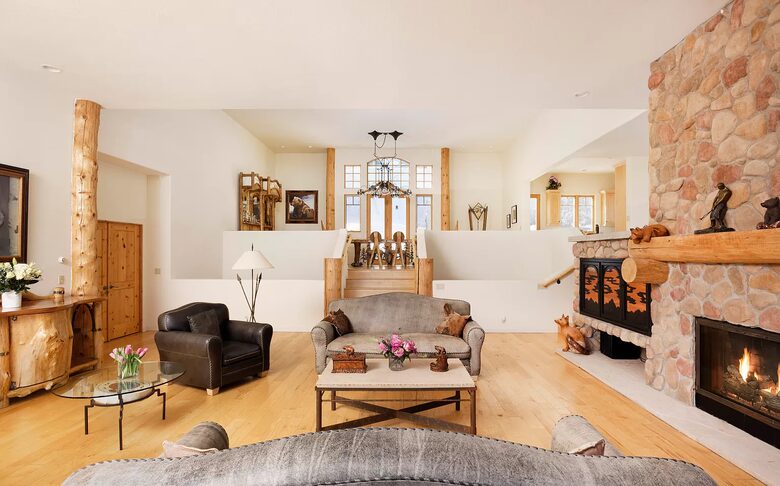 Home Exchange in Snowmass Village family room with stone fireplace