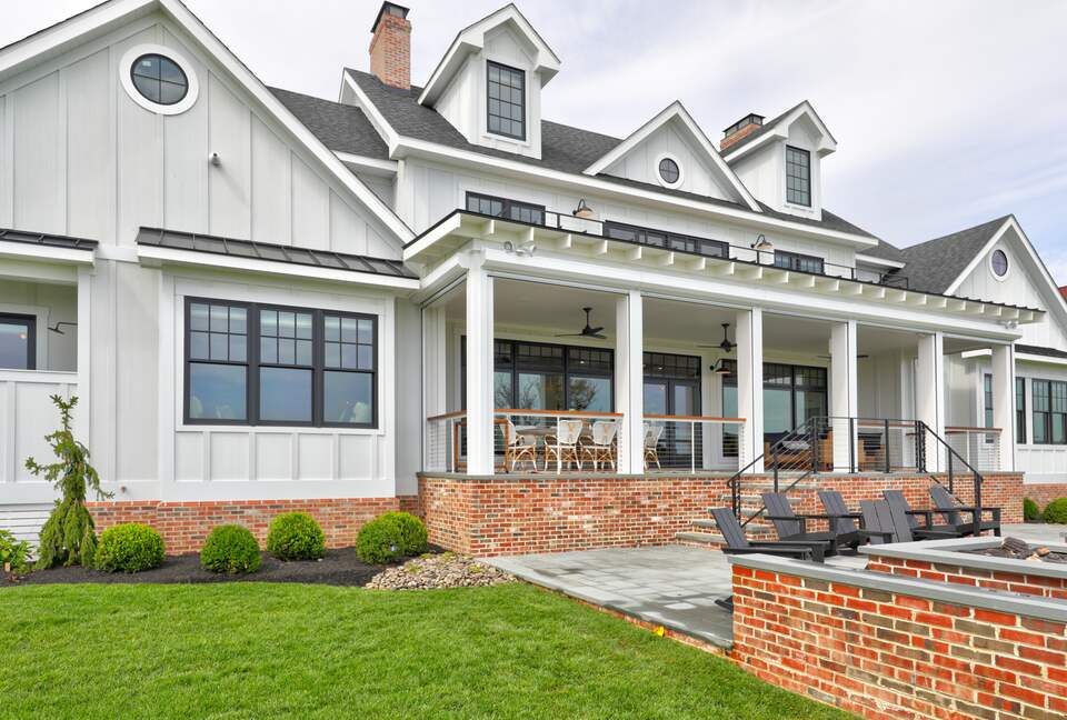bay side of home showing fire pit with adirondack chairs