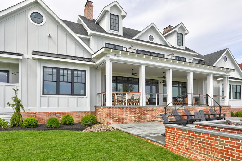 bay side of home showing fire pit with adirondack chairs