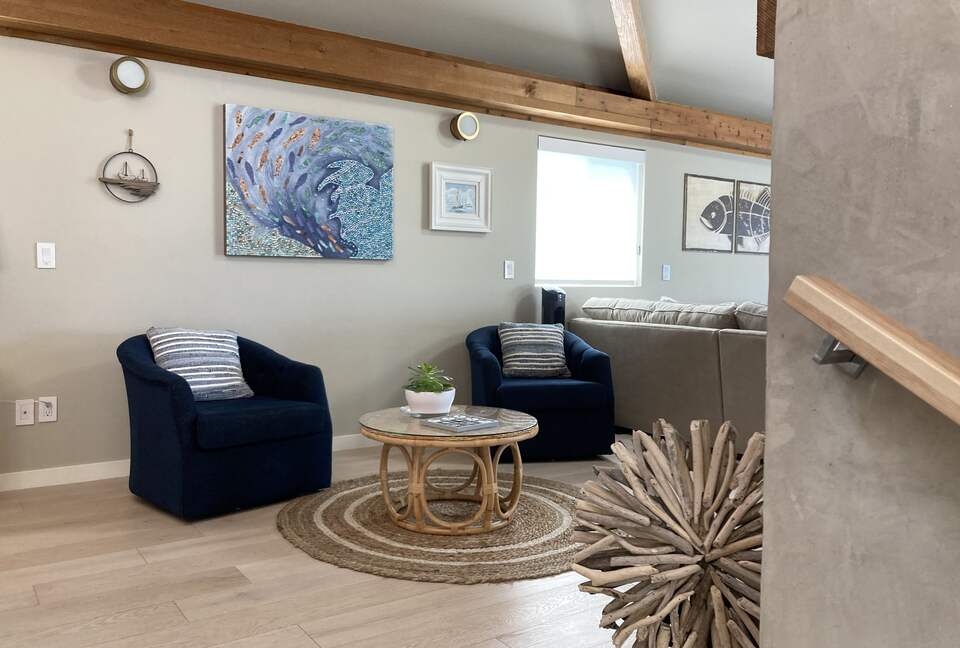 Swivel chair seating are for two at electric fireplace.