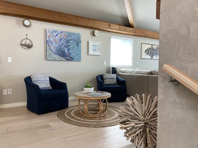 Swivel chair seating are for two at electric fireplace.