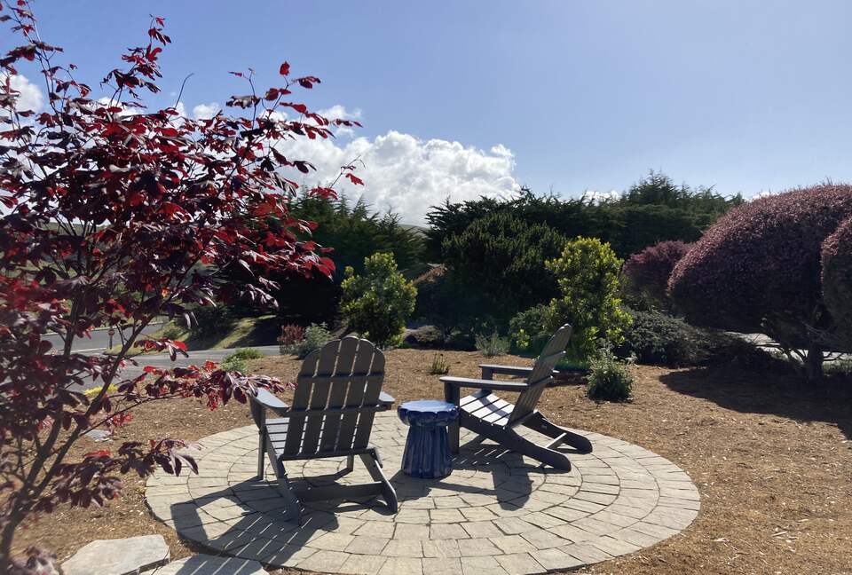 Front yard patio seating area with views of surrounding hills.
