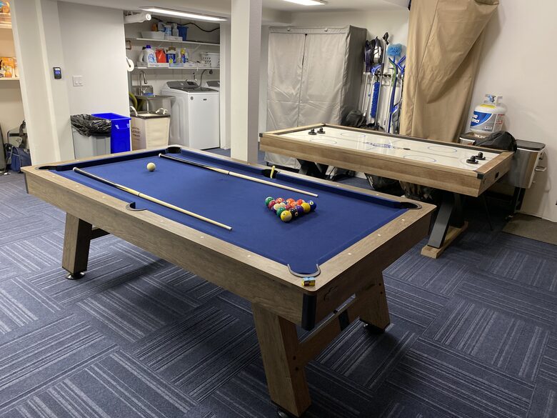 Garage has a game area for guest use.