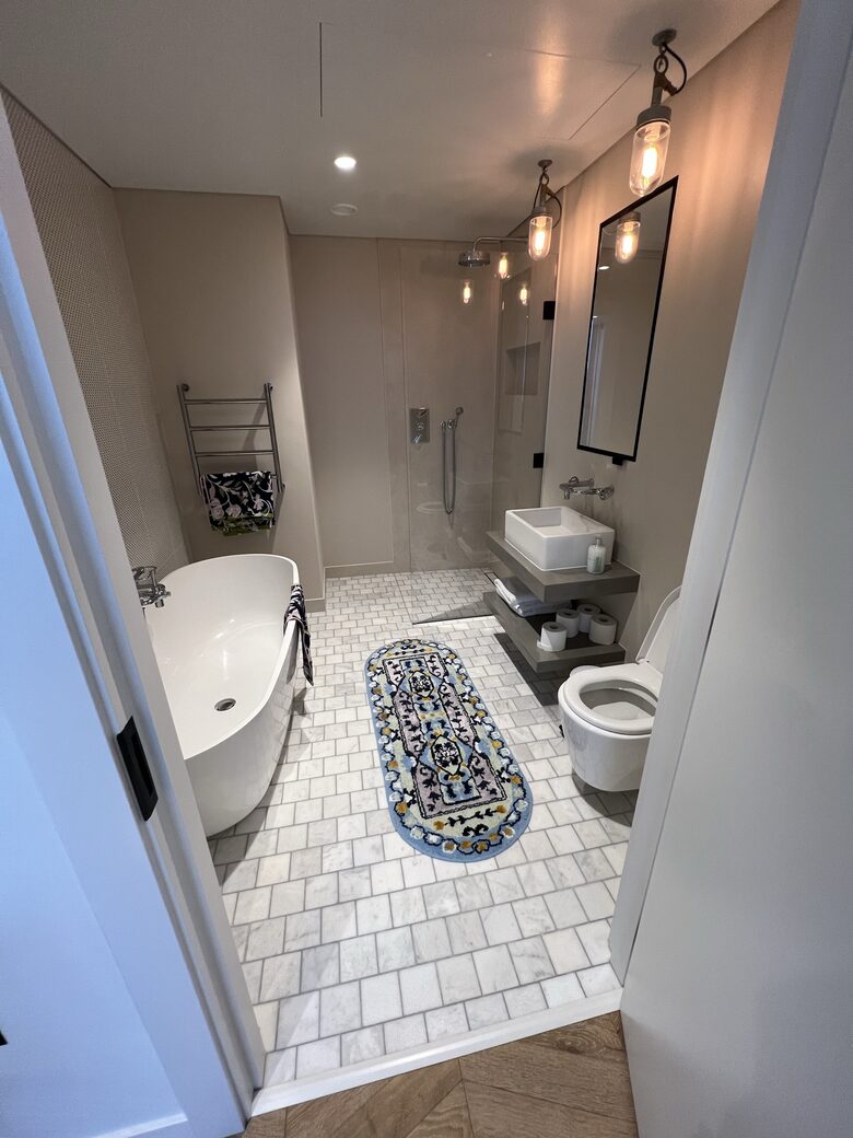 master bathroom with bath and shower