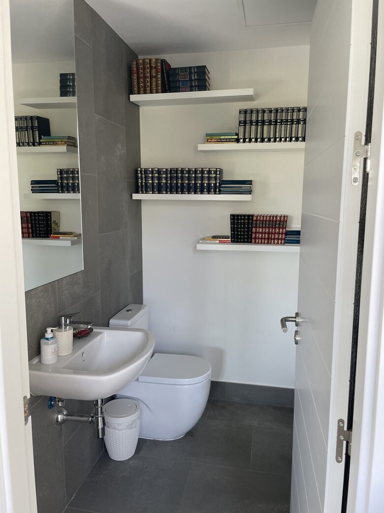 Small toilet next to the kitchen. We have books everywhere!