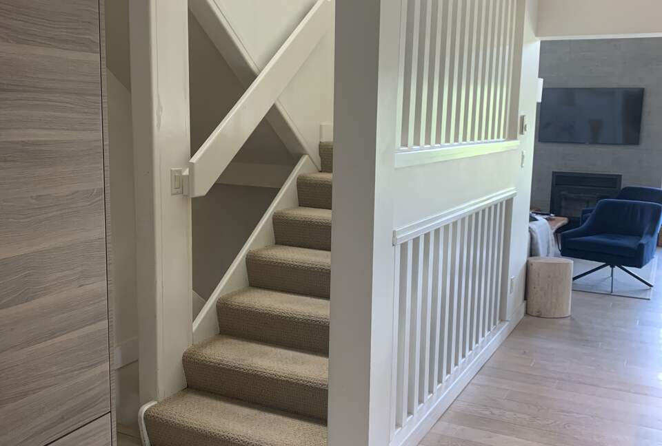 Staircase to top floor with 2 bedrooms, 1 bathroom