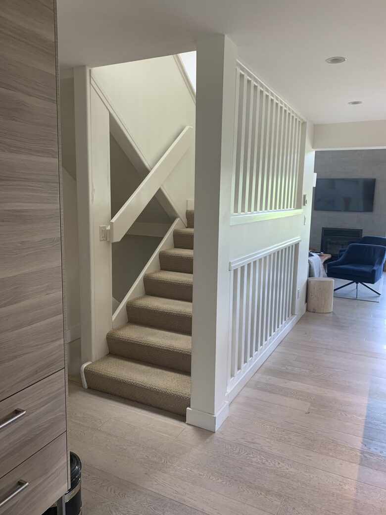 Staircase to top floor with 2 bedrooms, 1 bathroom