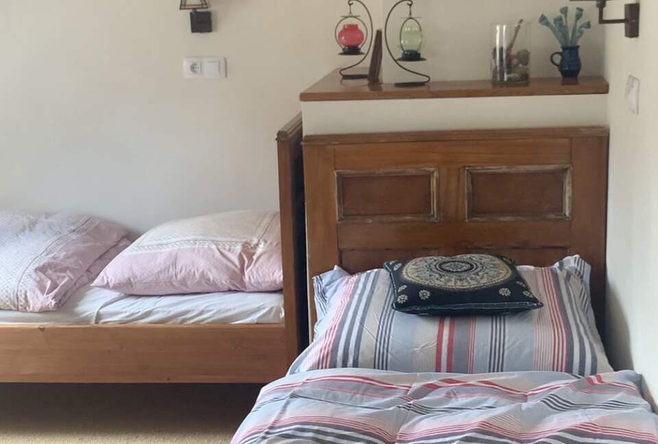 Another large upstairs room, with 2 single beds and 1 double