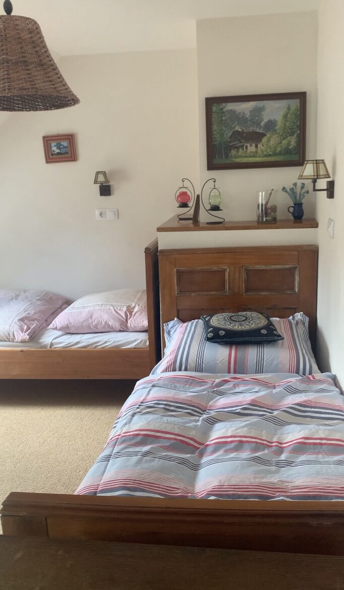 Another large upstairs room, with 2 single beds and 1 double