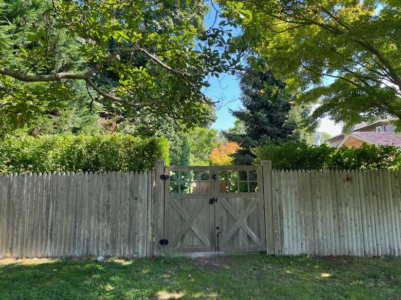 Landscaper gates closing off driveway from yard