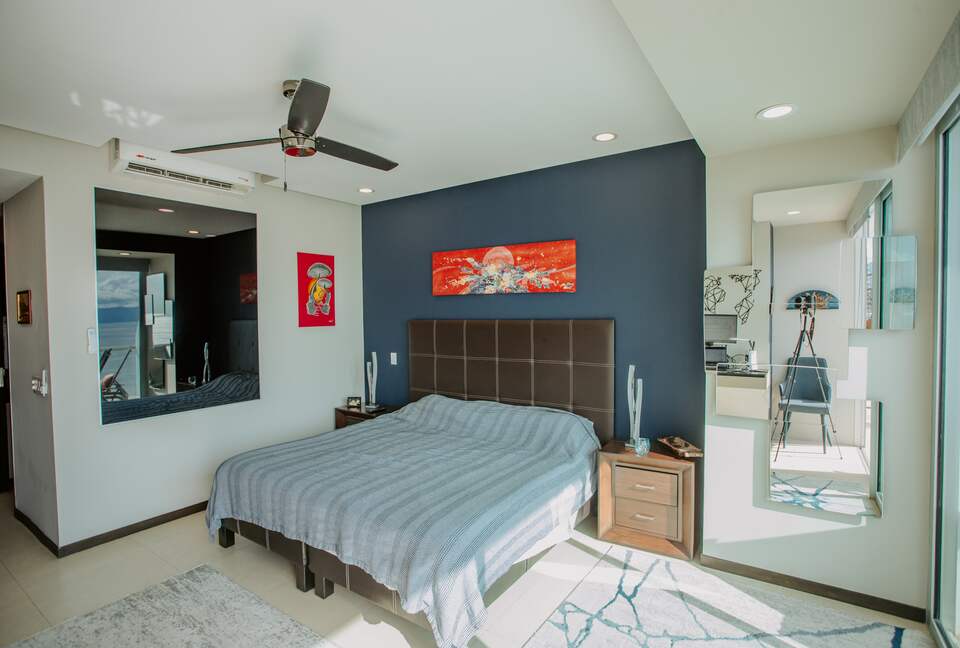 Spacious master with mirror brining ocean into the room